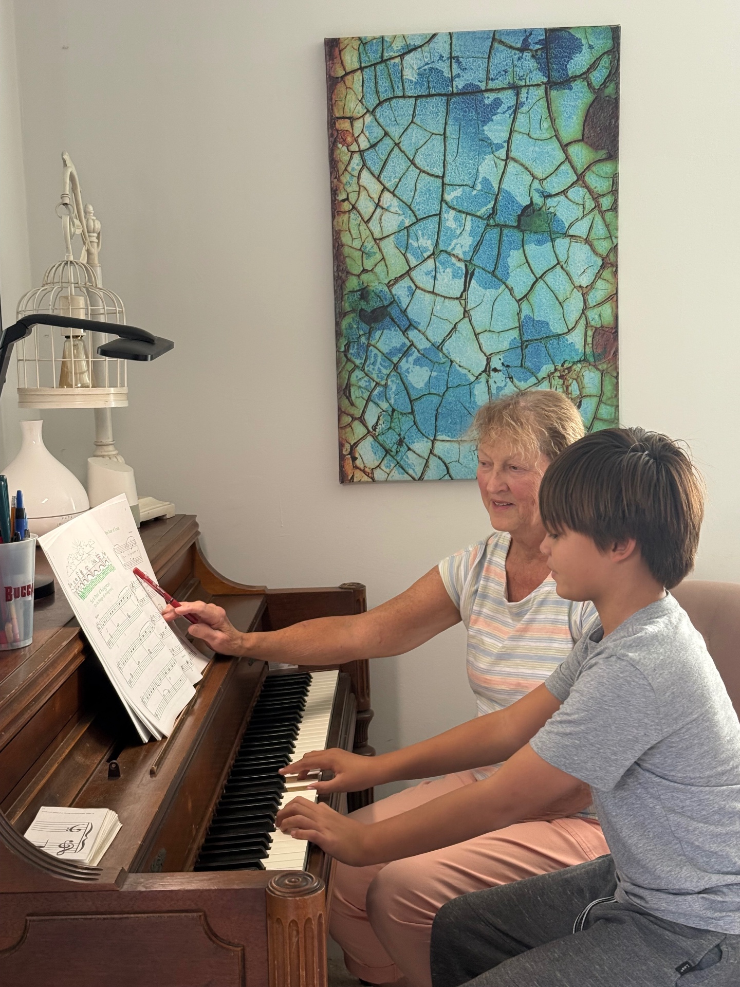 Bonnie teaching a young student at the piano