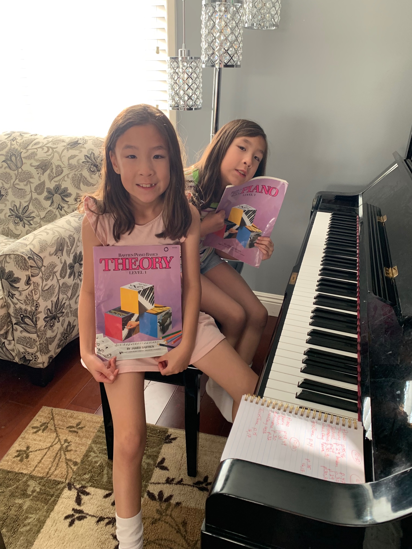 Two students with their Bastien piano method books
