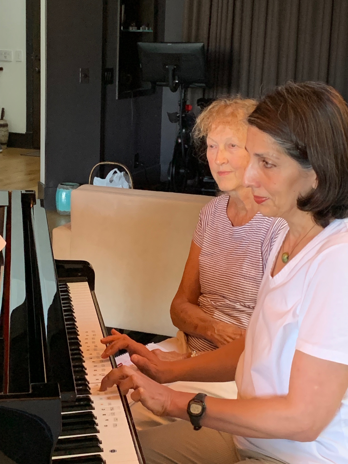 Adult student playing piano during a lesson