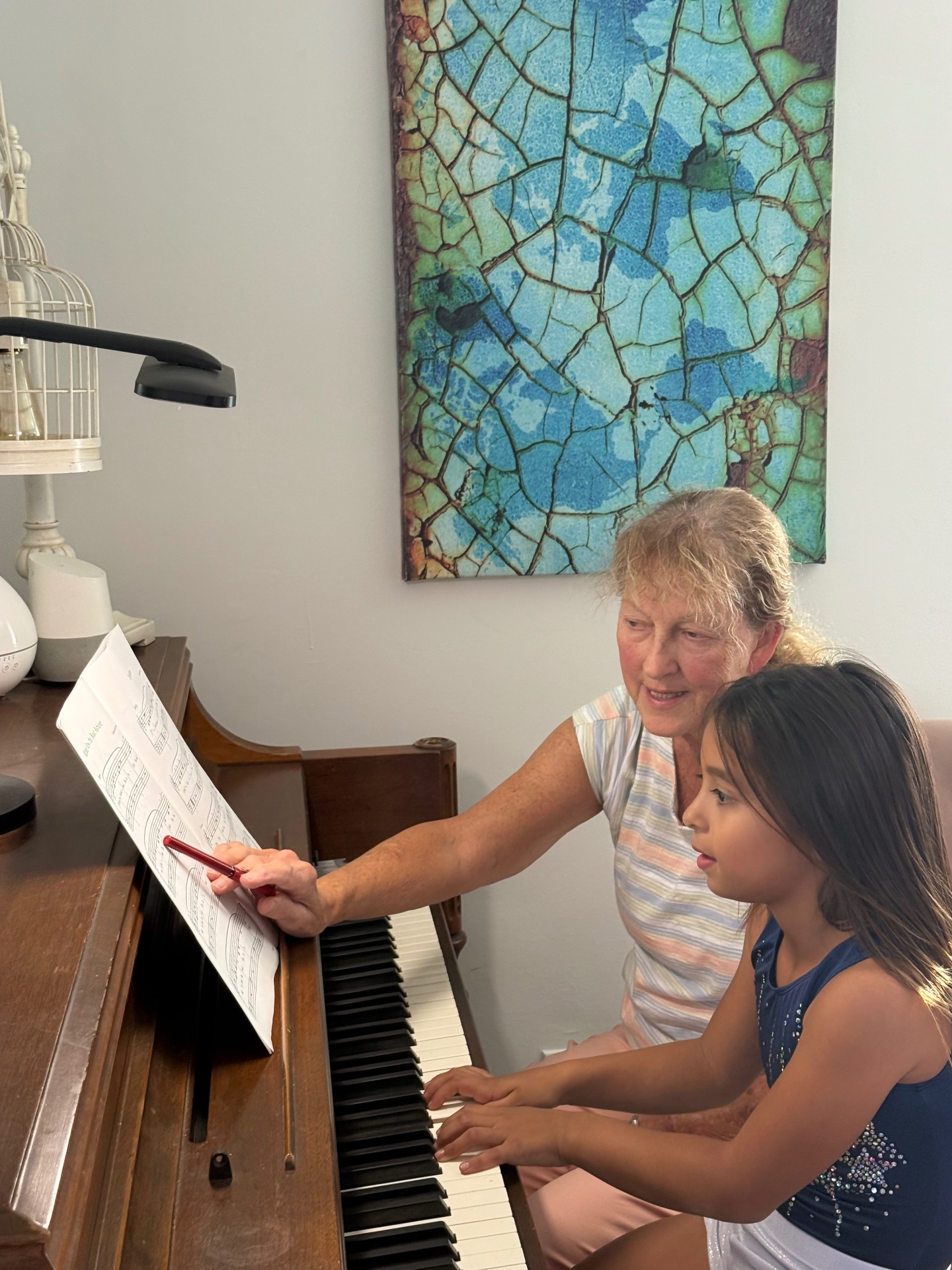 Bonnie pointing to sheet music with a student